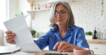 elderly woman looking at finances