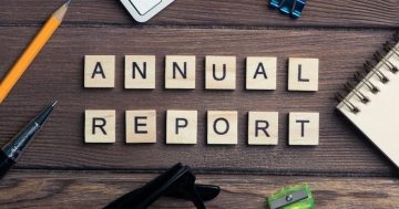 tiles on a desk spelling out the words annual report