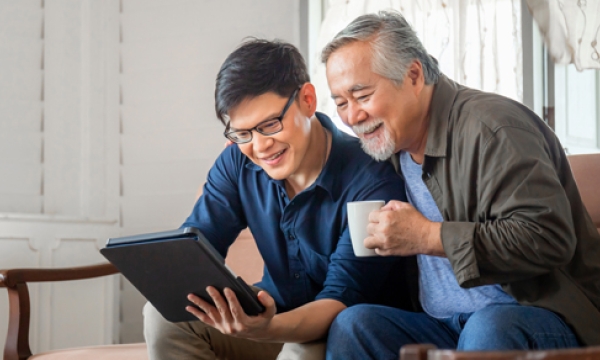 two men looking at tablet