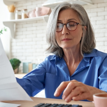 elderly woman looking at finances