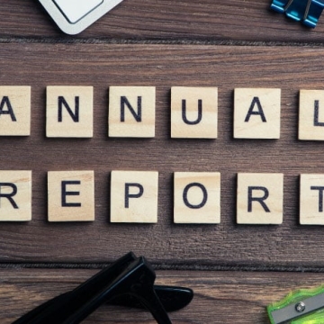 tiles on a desk spelling out the words annual report